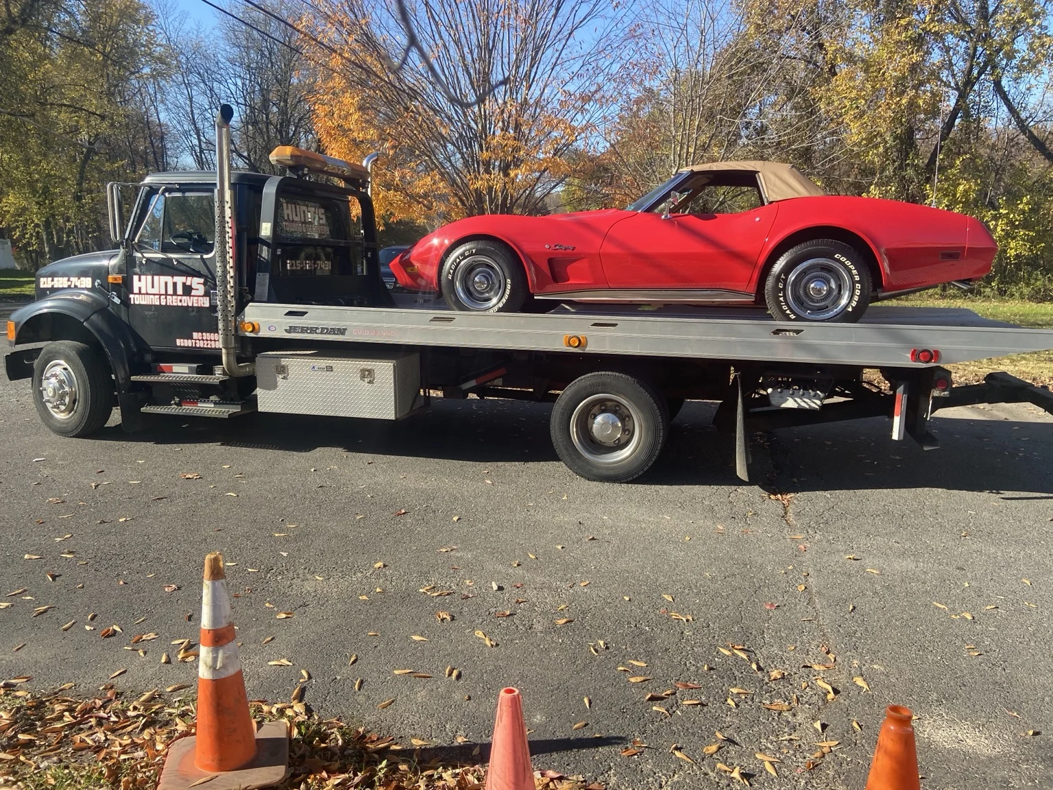 Red classic Corvette secured on the Hunt’s flatbed