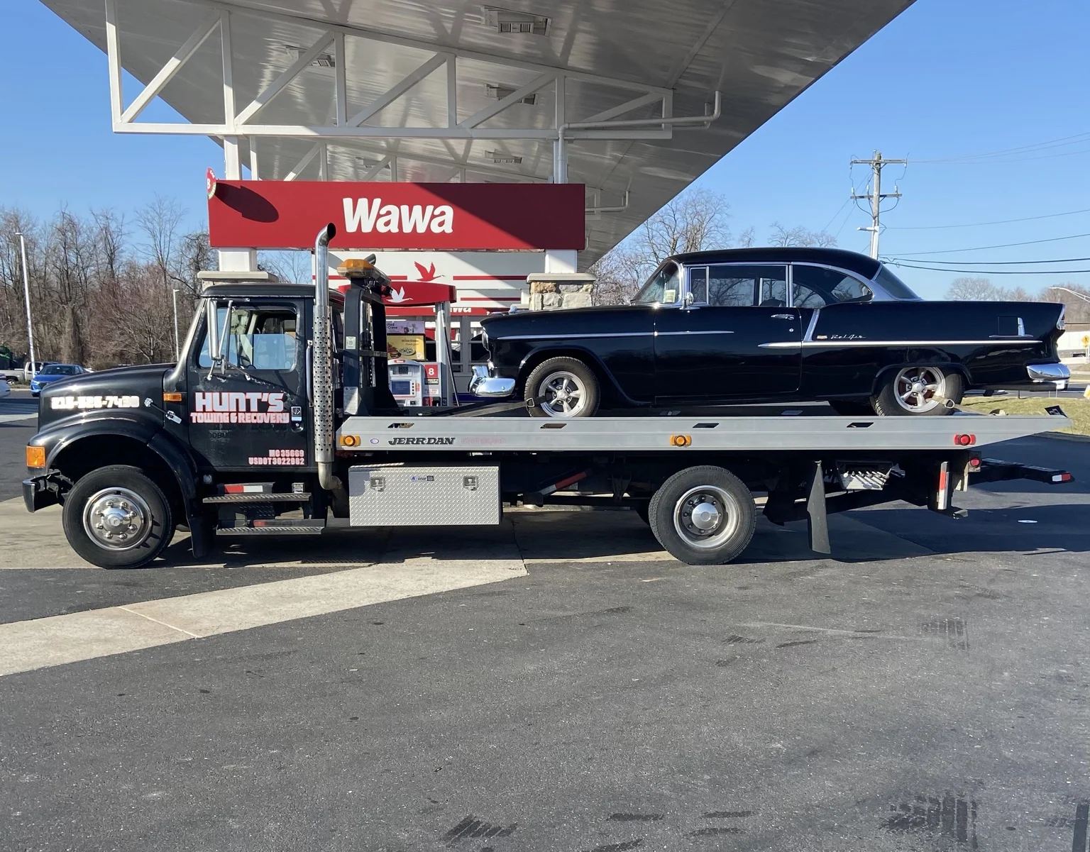 A beautifully kept classic Chevrolet being transported by Hunt’s