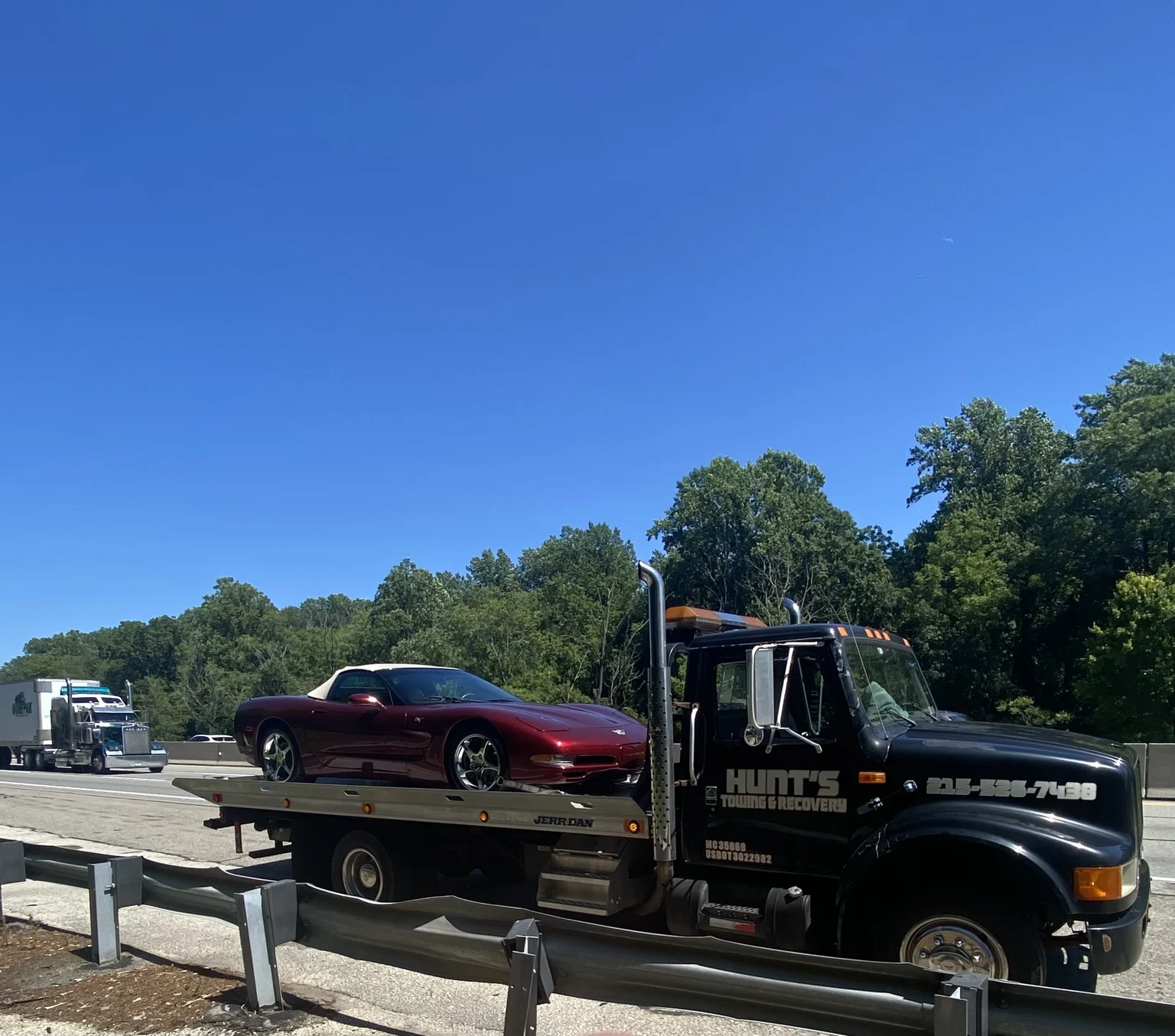 Red sports car being transported on the Hunt’s flatbed