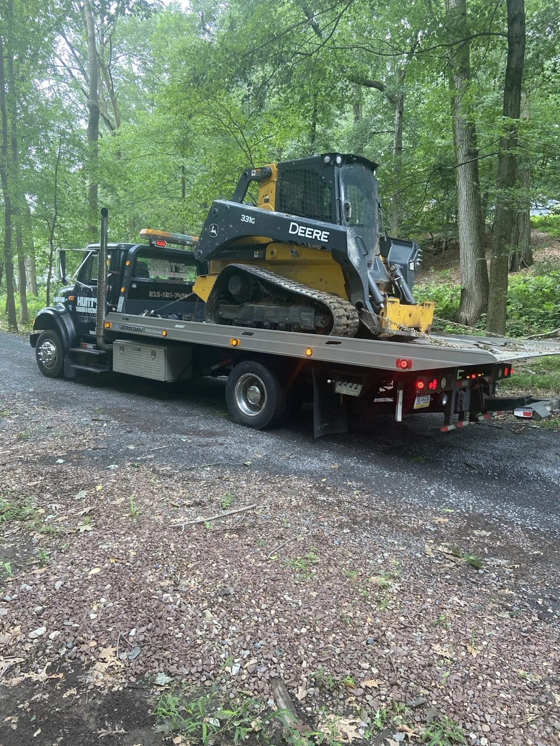 John Deere construction equipment on the flatbed