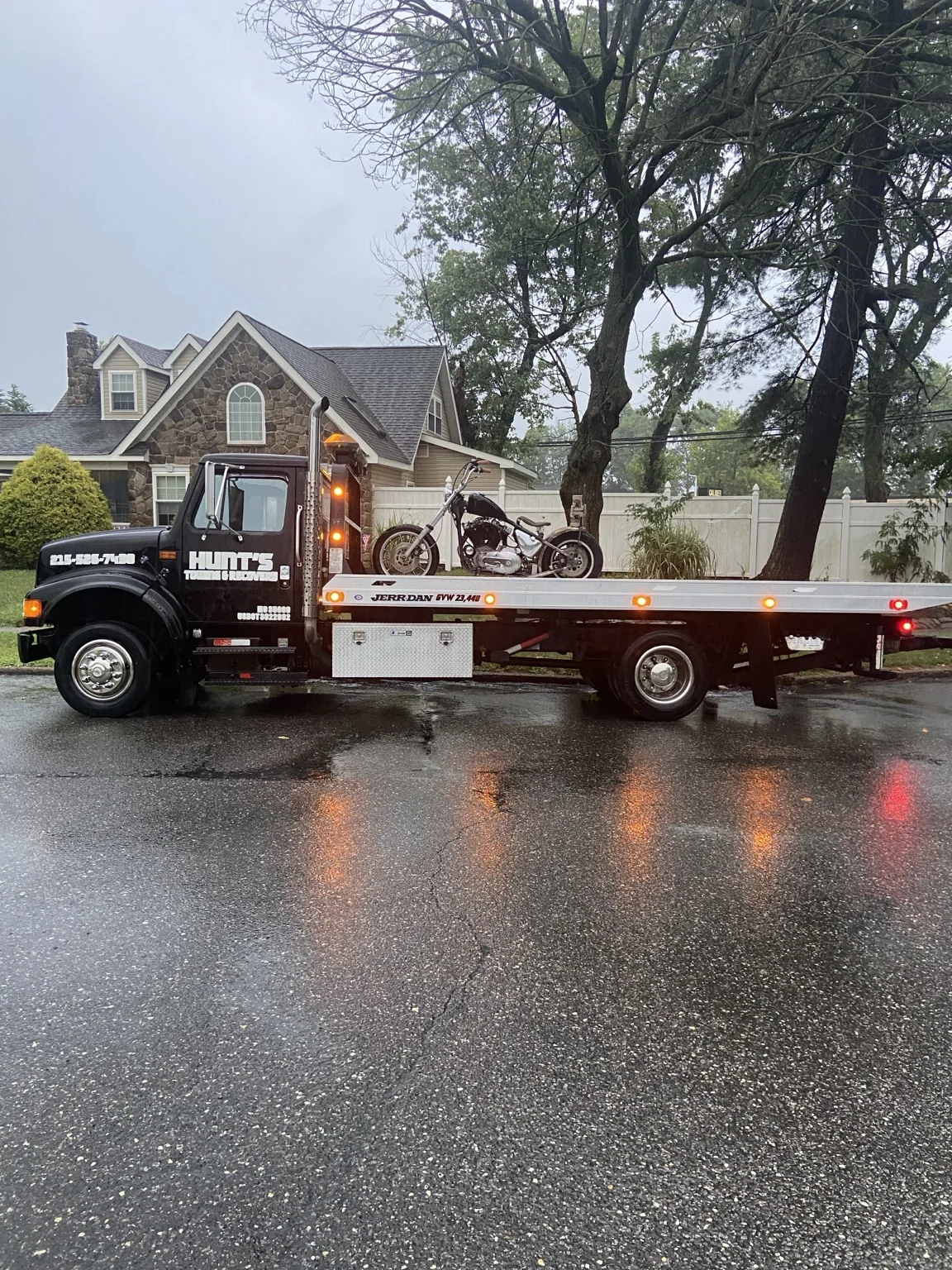 Motorcycles loaded on the flatbed on a rainy day